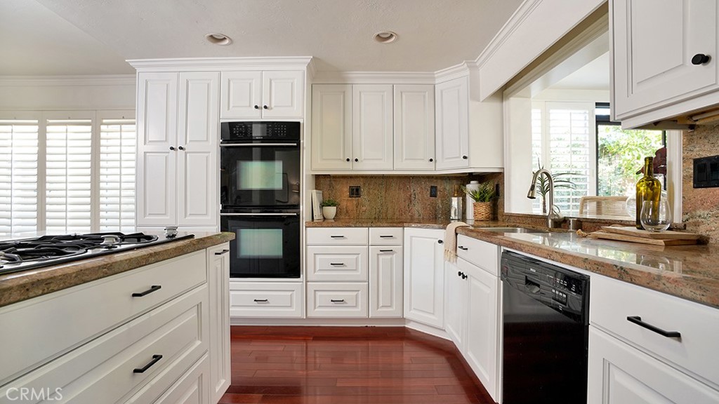 25312 Pizarro Road Lake Forest, CA 92630 - Photo 23 of 36 a kitchen with granite countertop white cabinets and stainless steel appliances