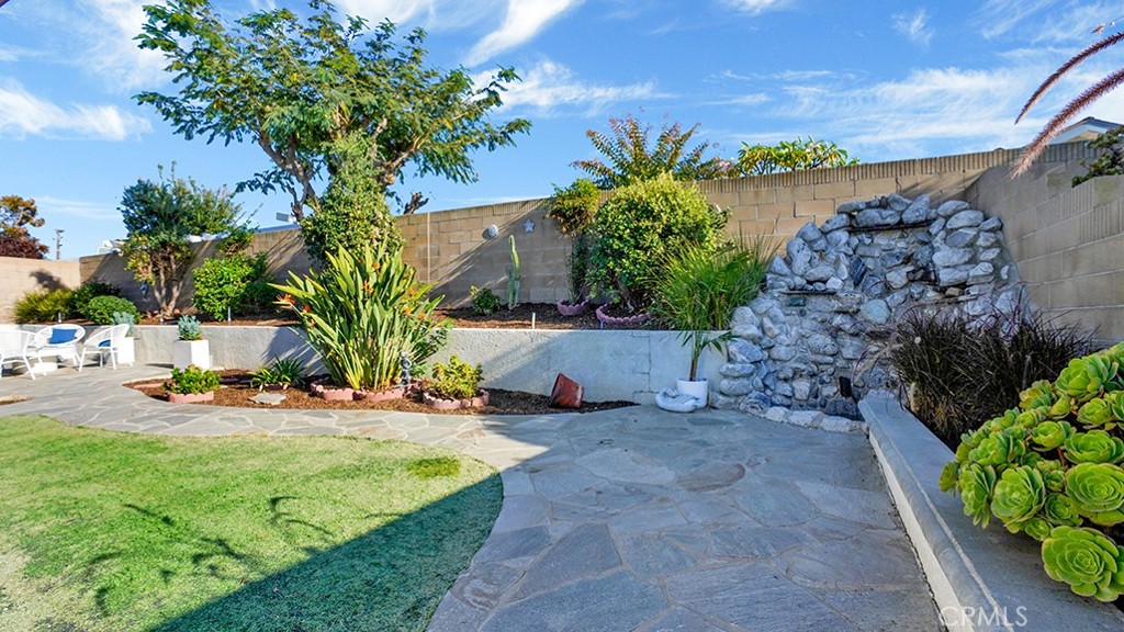 25312 Pizarro Road Lake Forest, CA 92630 - Photo 29 of 36 a view of a backyard with plants and palm trees
