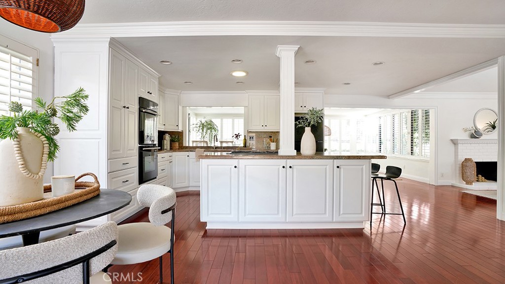 25312 Pizarro Road Lake Forest, CA 92630 - Photo 3 of 36 a kitchen with white cabinets and chairs