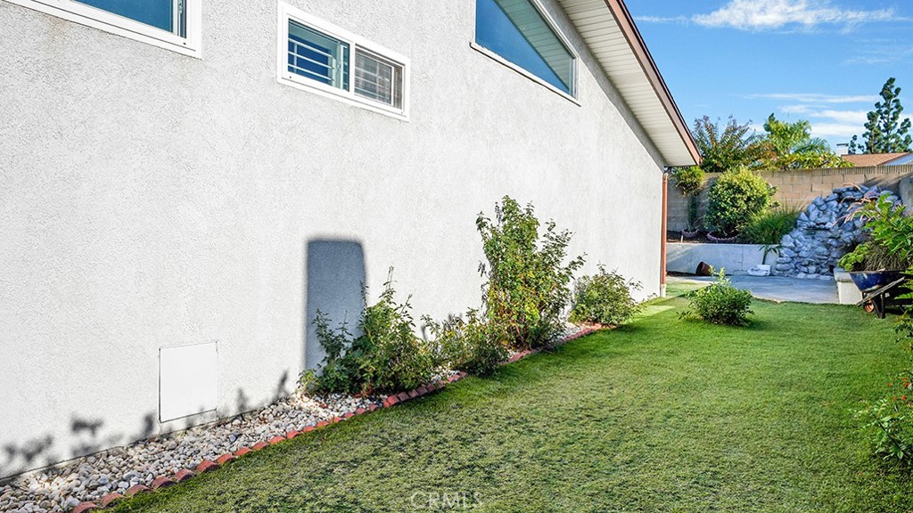 25312 Pizarro Road Lake Forest, CA 92630 - Photo 31 of 36 a view of a backyard with plants and a bench