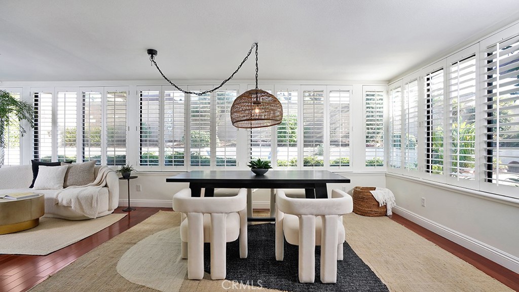 25312 Pizarro Road Lake Forest, CA 92630 - Photo 6 of 36 a dining room with furniture a chandelier and wooden floor