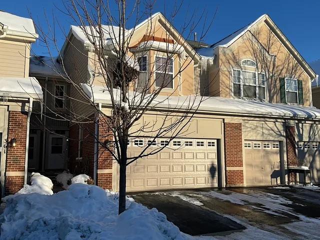 a view of a house with a snow on the road