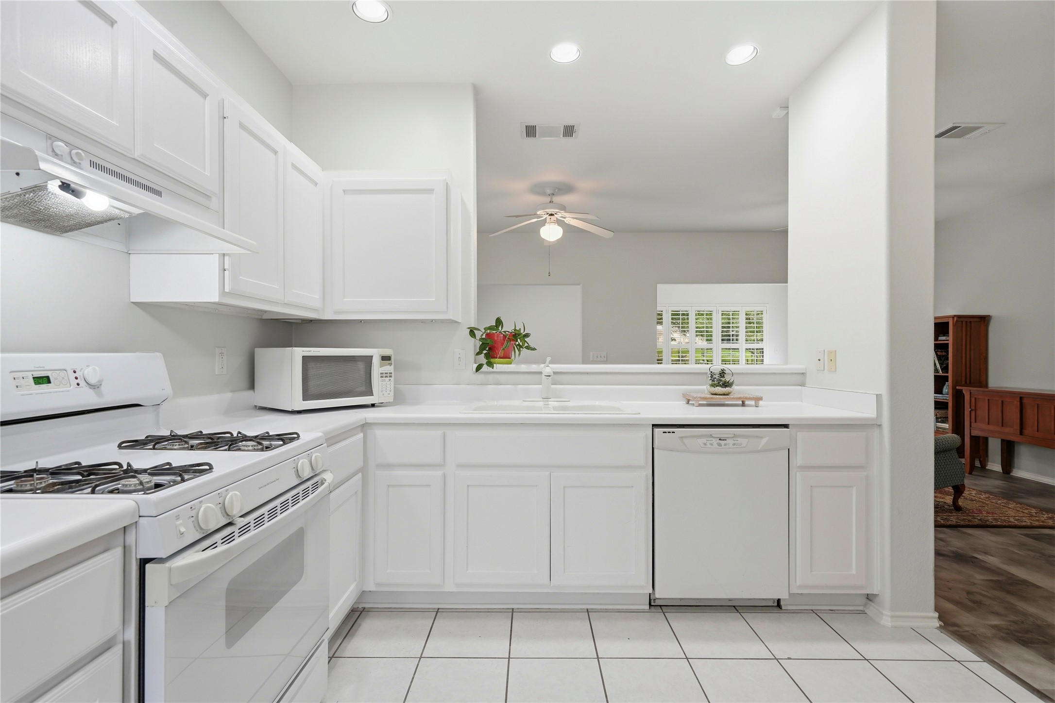 117 Whitewing Way Georgetown, TX 78633 - Photo 5 of 27 A well-lit kitchen with sleek white cabinetry and appliances.
