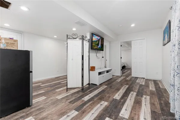 a view of hallway with wooden floor