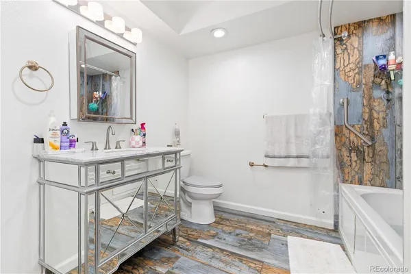 a bathroom with a sink toilet and a mirror