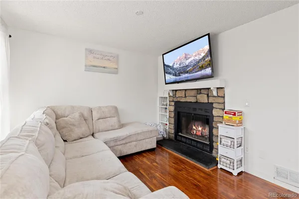a living room with furniture and a fireplace