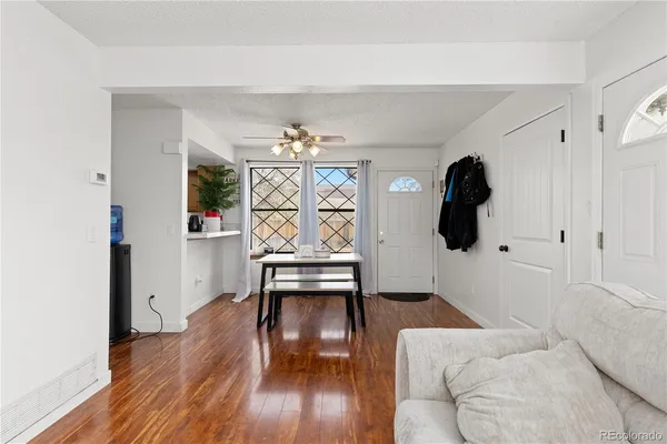 a living room with furniture and a wooden floor