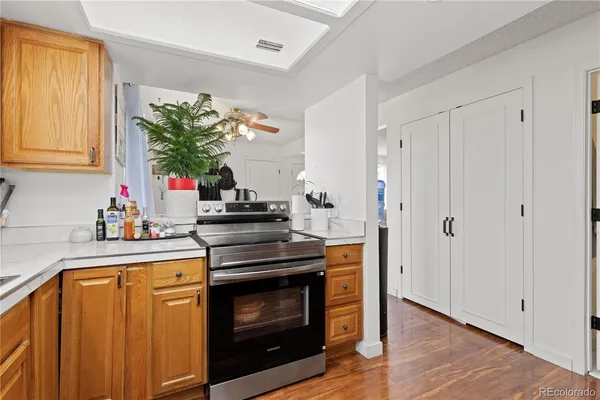 a kitchen with stainless steel appliances a stove a sink and a potted plant