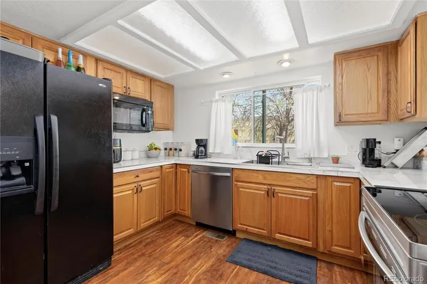 a kitchen with a refrigerator sink and cabinets