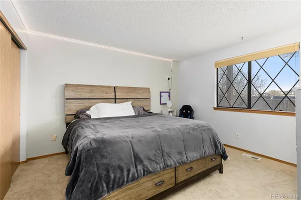 a bedroom with a bed and window