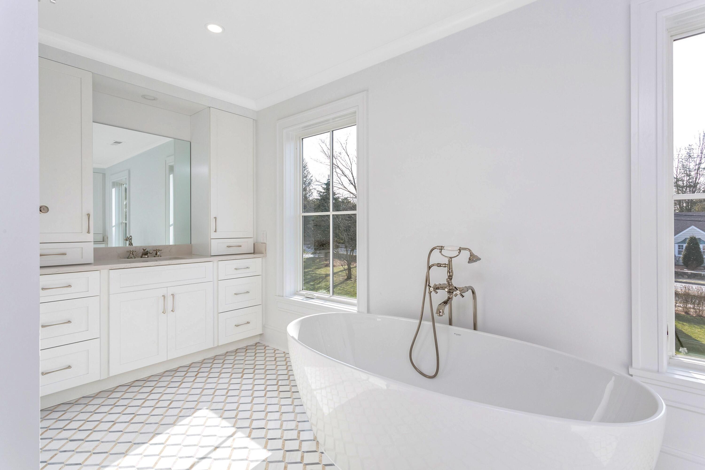 159 Middlesex Road Darien, CT 06820 - Photo 22 of 38 a bathroom with a tub sink and mirror