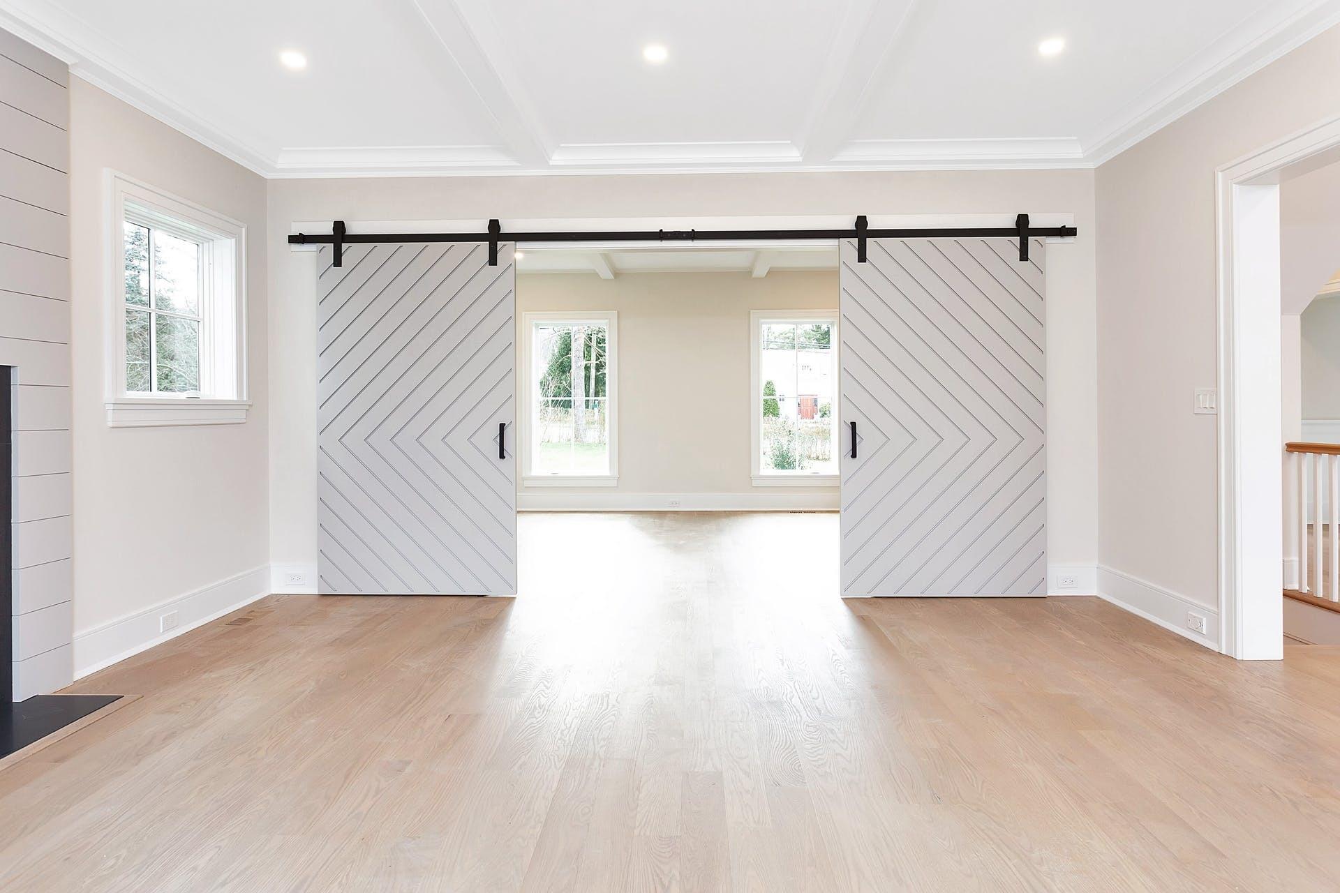 159 Middlesex Road Darien, CT 06820 - Photo 7 of 38 a view of a big room with wooden floor ceiling fan and windows