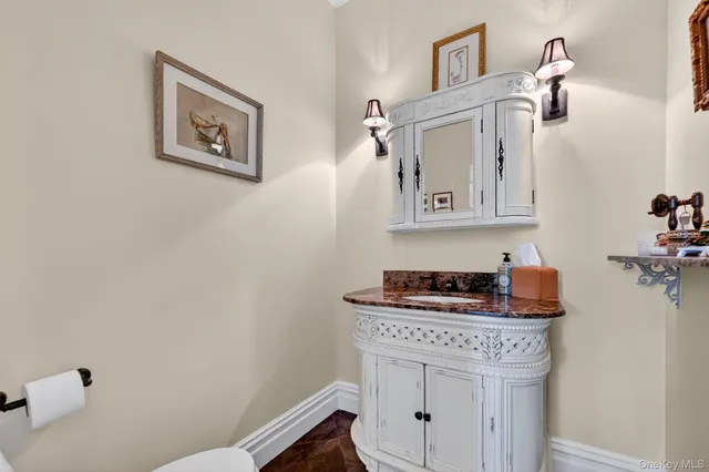 a bathroom with a stove a sink and cabinets