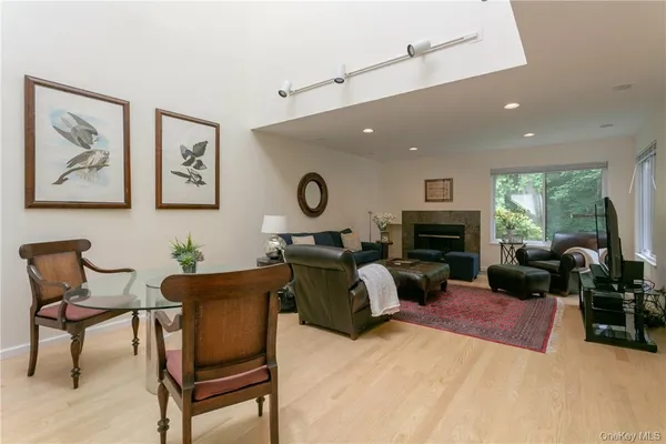 a living room with furniture a fireplace and a large window