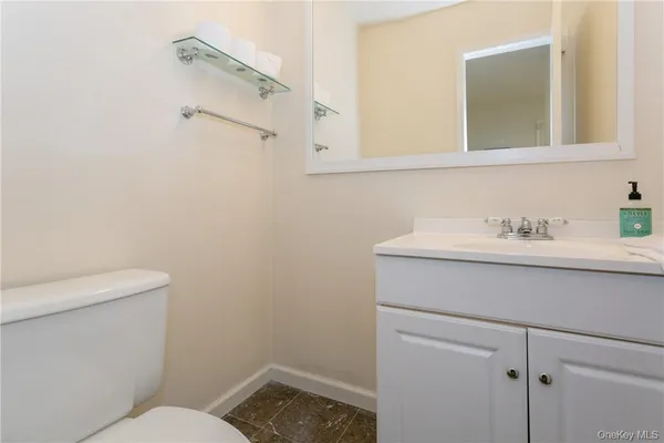 a bathroom with a sink mirror and toilet
