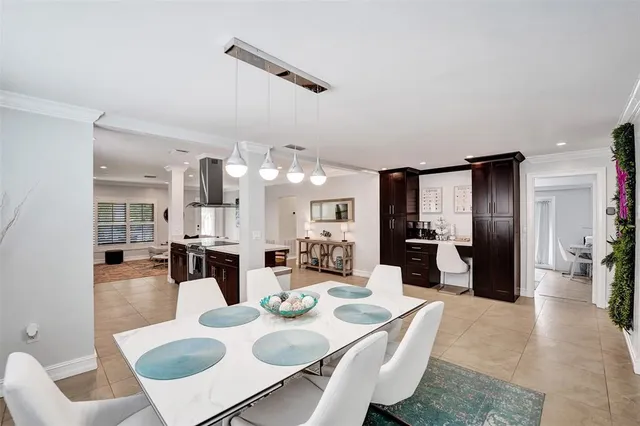 a large kitchen with a table and chairs