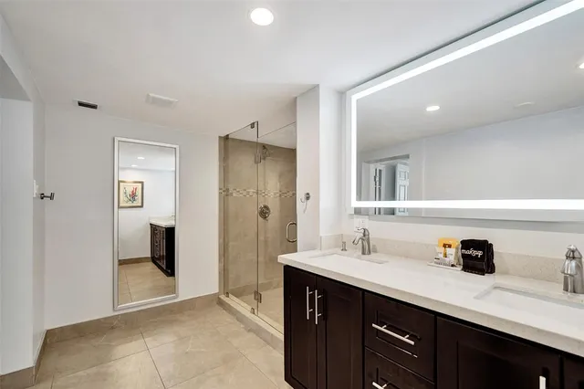 a spacious bathroom with a sink a mirror and shower
