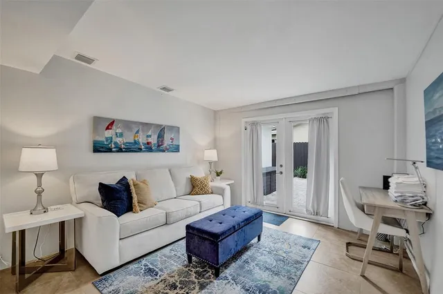 a living room with furniture and a lamp