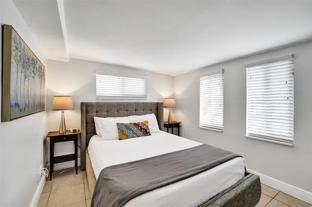 a bedroom with a bed and a night stand