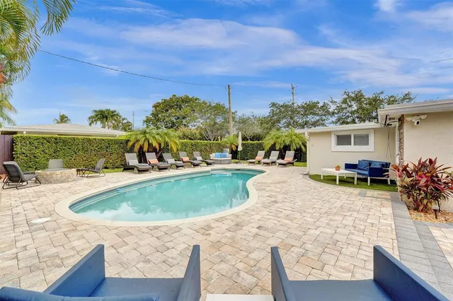 a view of a swimming pool with an outdoor seating