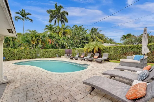 a view of a swimming pool and lounge chair