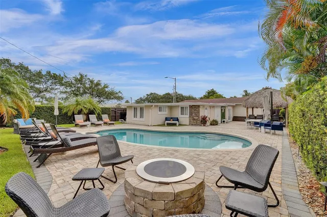 a view of a swimming pool with outdoor seating