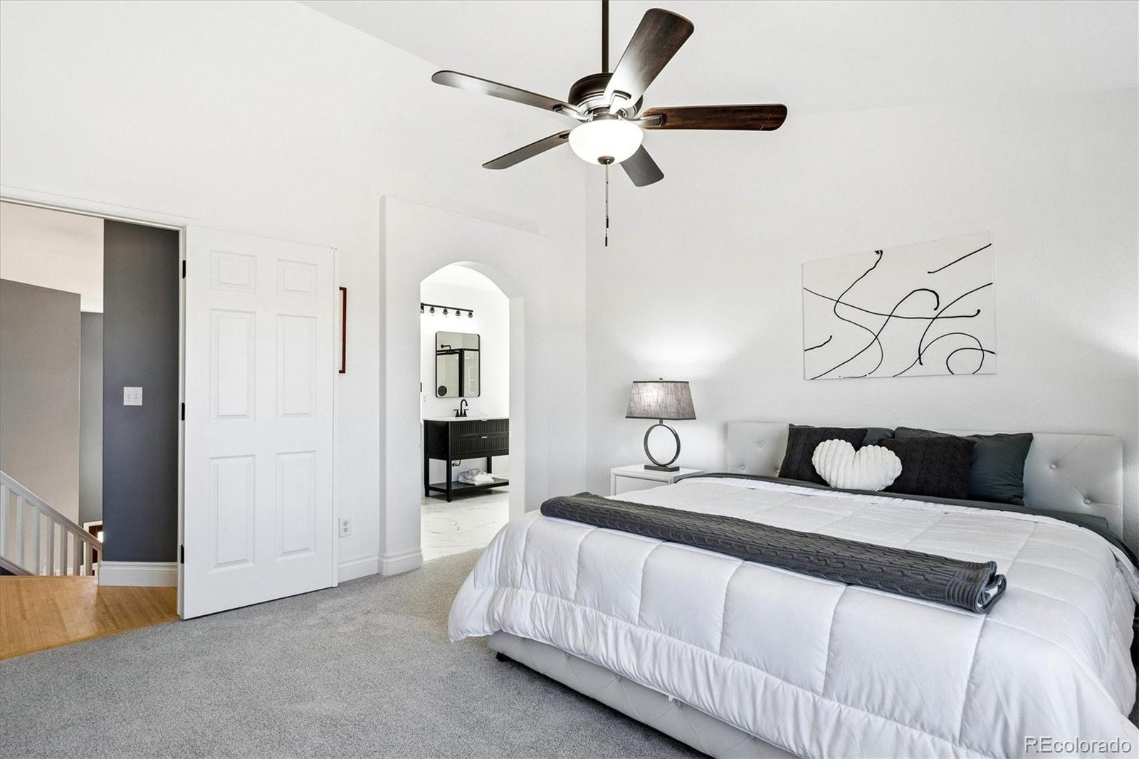 4143 South Deframe Court Morrison, CO 80465 - Photo 31 of 48 a bedroom with a bed and ceiling fan