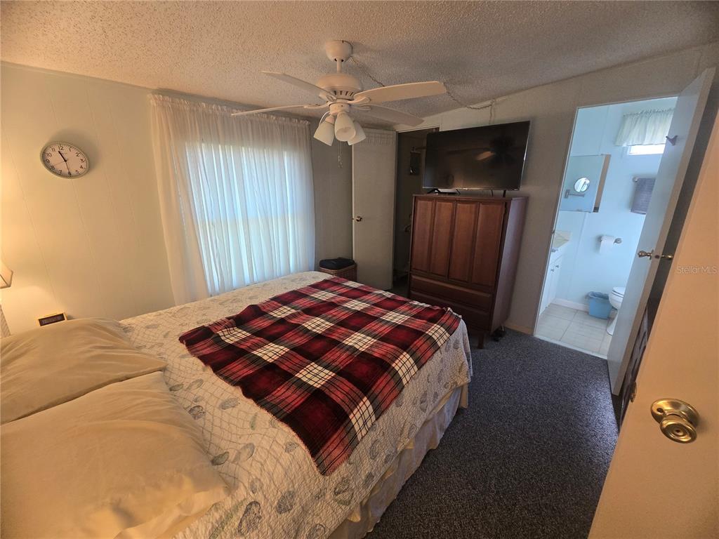 1710 7th Street Southwest, Unit 59 Ruskin, FL 33570 - Photo 12 of 31 a bedroom with a large bed and a closet