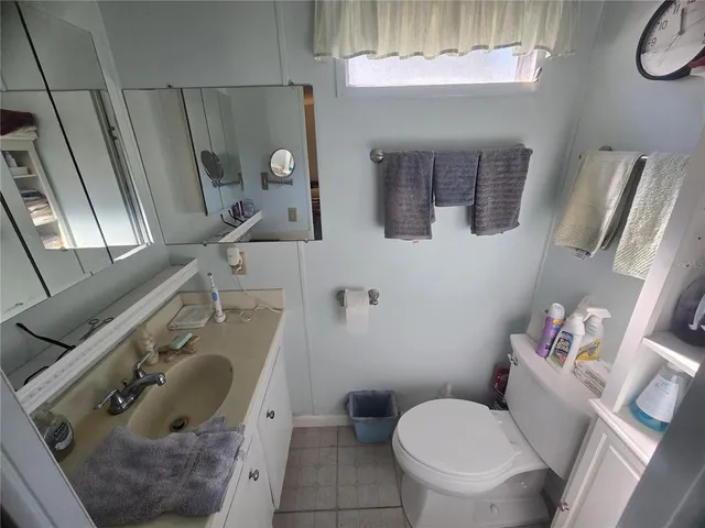 a bedroom with a bed couch and window