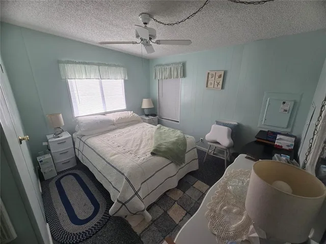 a bedroom with a bed dresser and a mirror