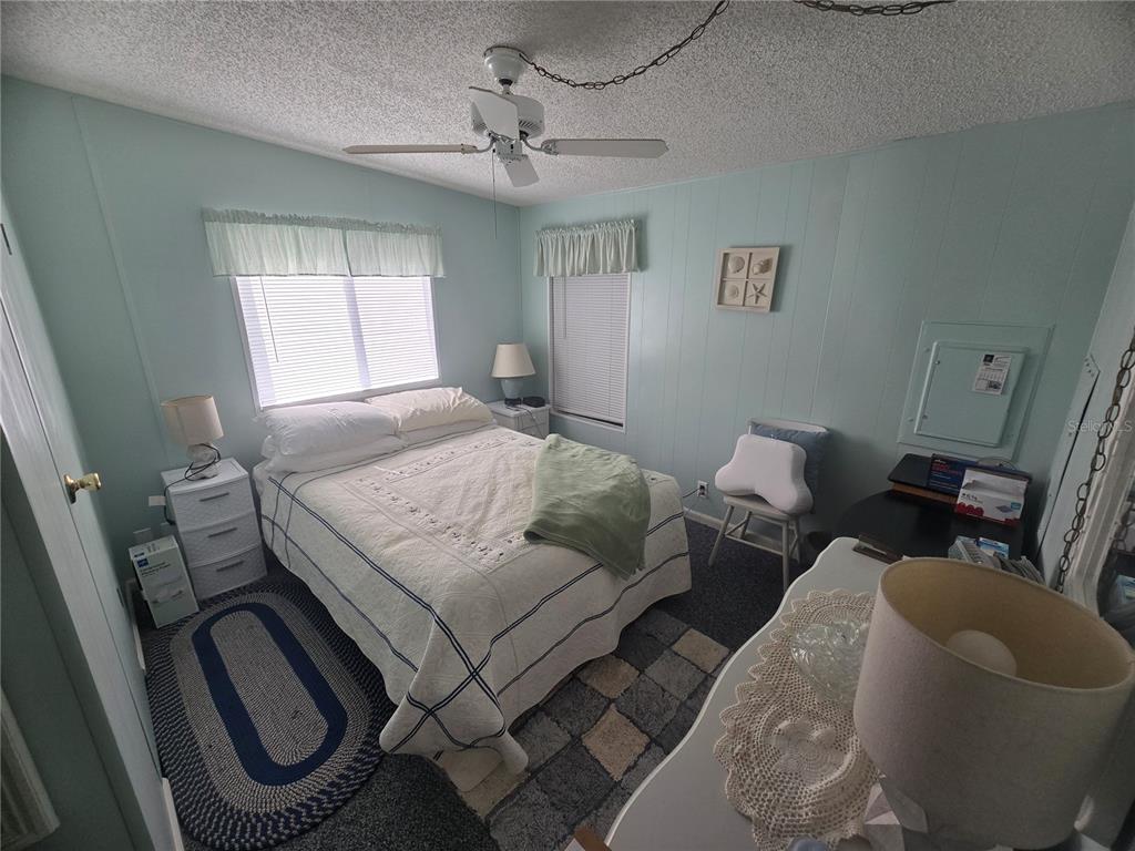 1710 7th Street Southwest, Unit 59 Ruskin, FL 33570 - Photo 15 of 31 a bedroom with a bed couch and window