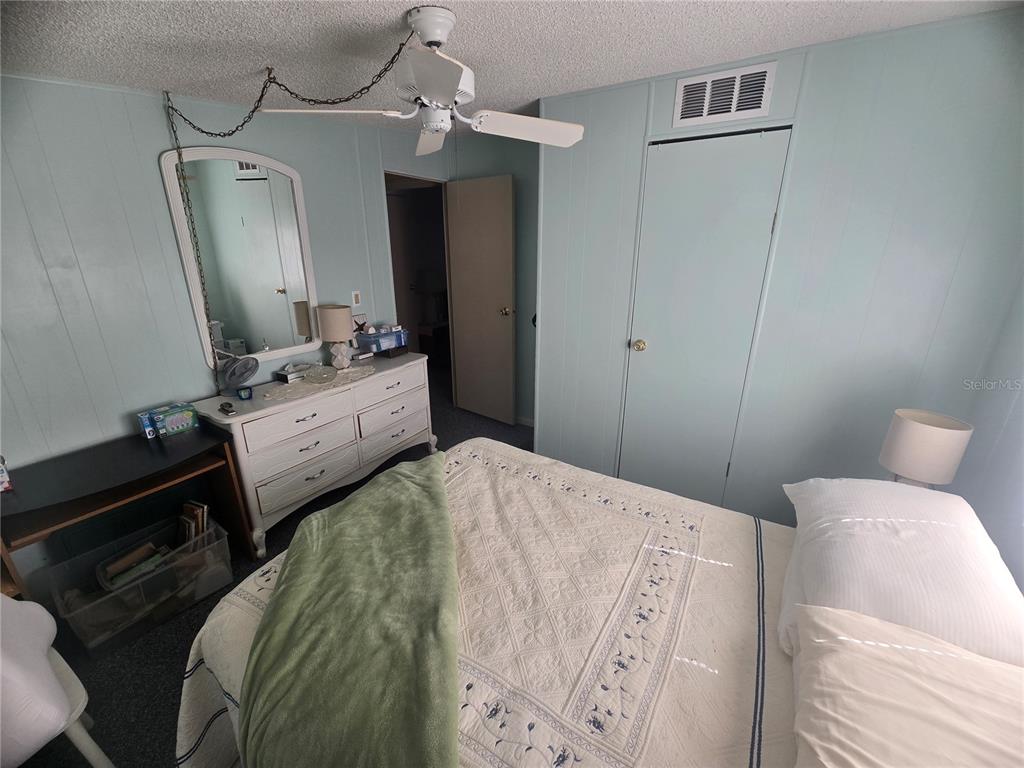1710 7th Street Southwest, Unit 59 Ruskin, FL 33570 - Photo 16 of 31 a bedroom with a bed dresser and a mirror
