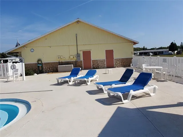 a patio with glass top table and chairs