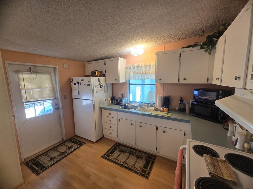 1710 7th Street Southwest, Unit 59 Ruskin, FL 33570 - Photo 4 of 31 a kitchen with refrigerator and window