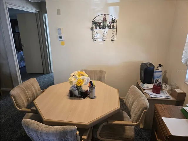 a dining room with furniture and wooden floor