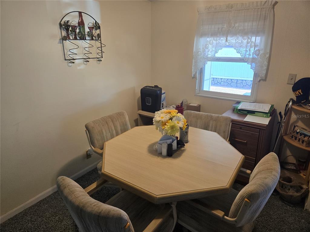1710 7th Street Southwest, Unit 59 Ruskin, FL 33570 - Photo 7 of 31 a dining room with furniture and window