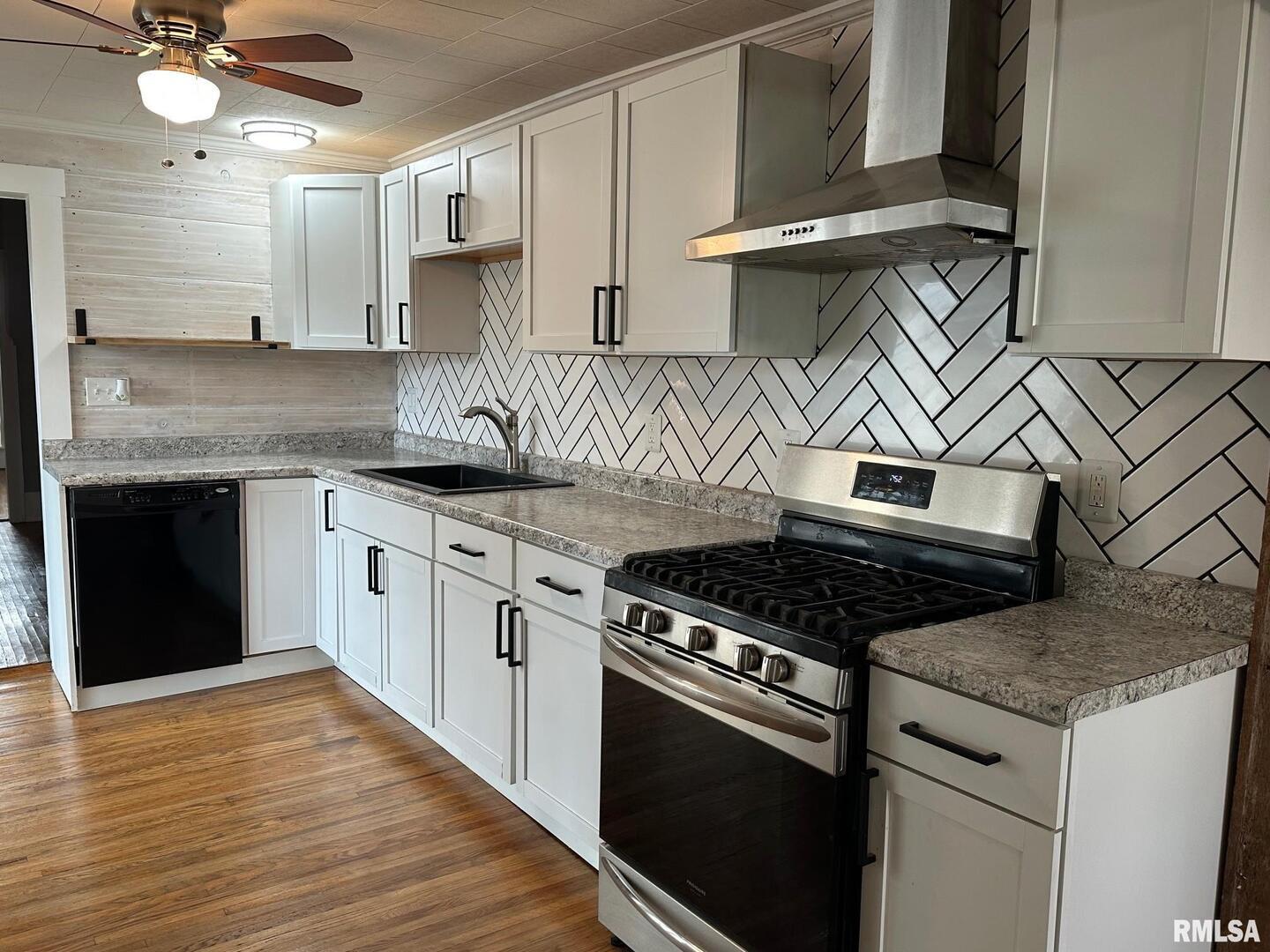 323 Lincoln Street Miles, IA 52064 - Photo 29 of 34 a kitchen with stainless steel appliances granite countertop a stove and a sink