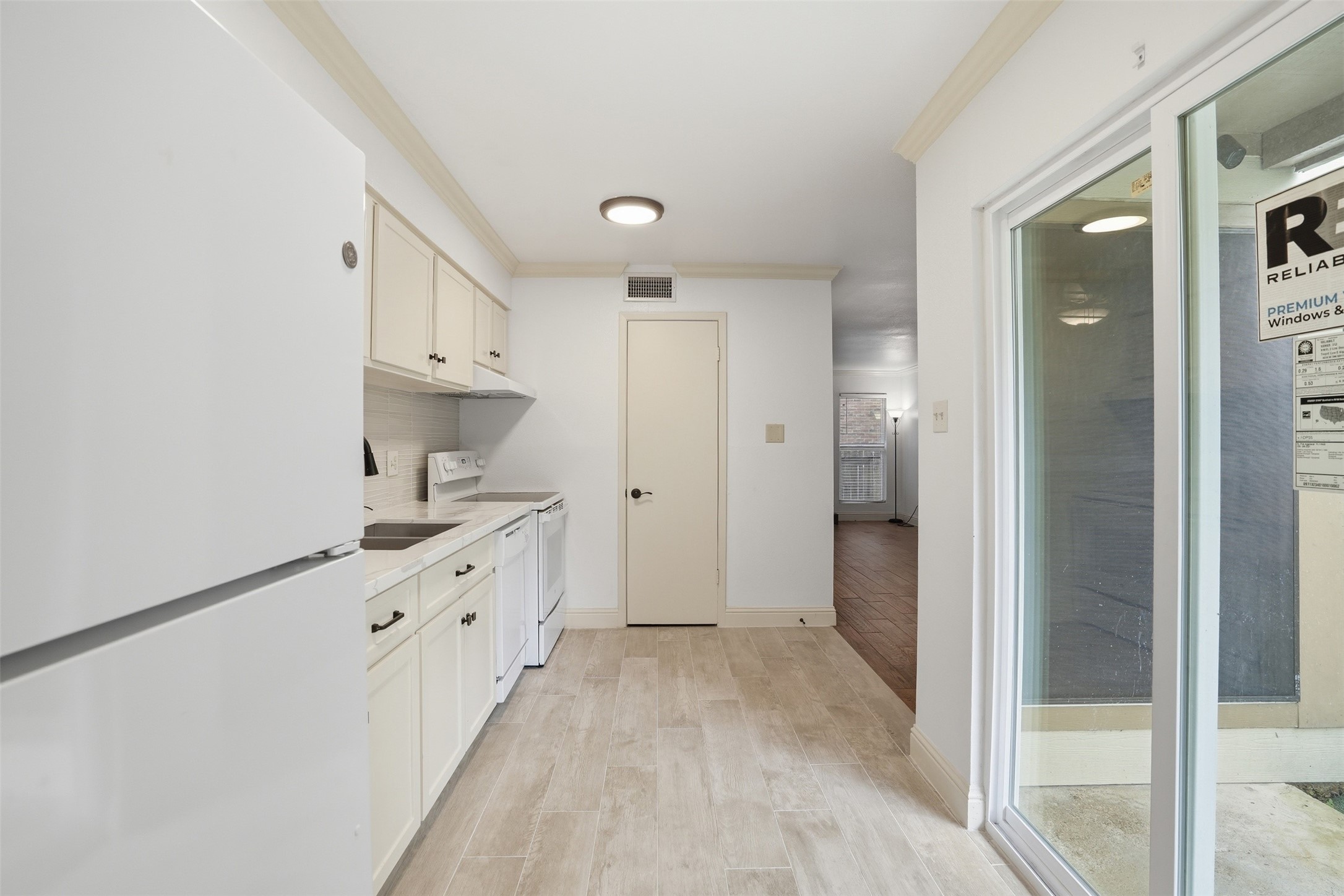 2200 Cypress Landing Road, Unit A3 Houston, TX 77090 - Photo 8 of 17 Light-filled kitchen with ample cabinet space and easy access to patio and utility room.