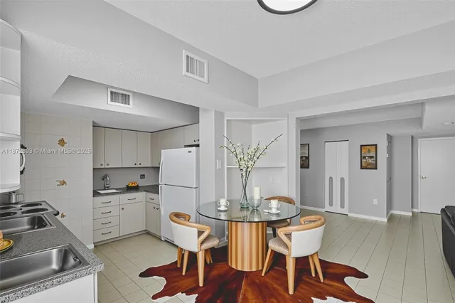 a kitchen with a table and chairs in it
