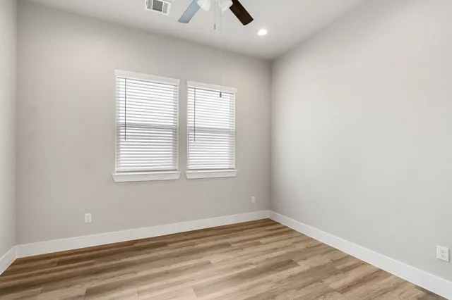 a view of an empty room and wooden floor