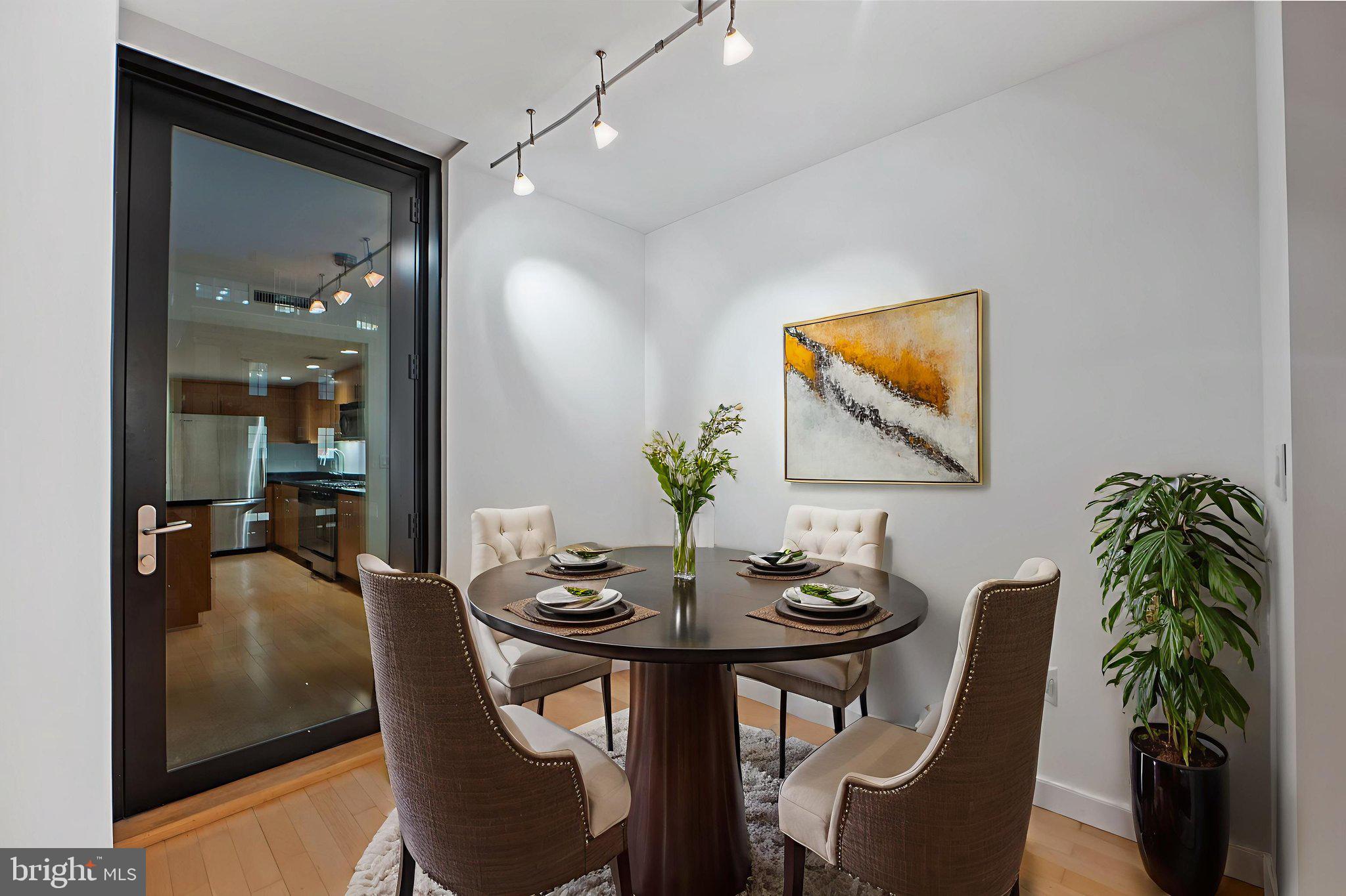 912 F Street Northwest, Unit 508 Washington, DC 20004 - Photo 16 of 40 a view of a dining room with furniture and wooden floor