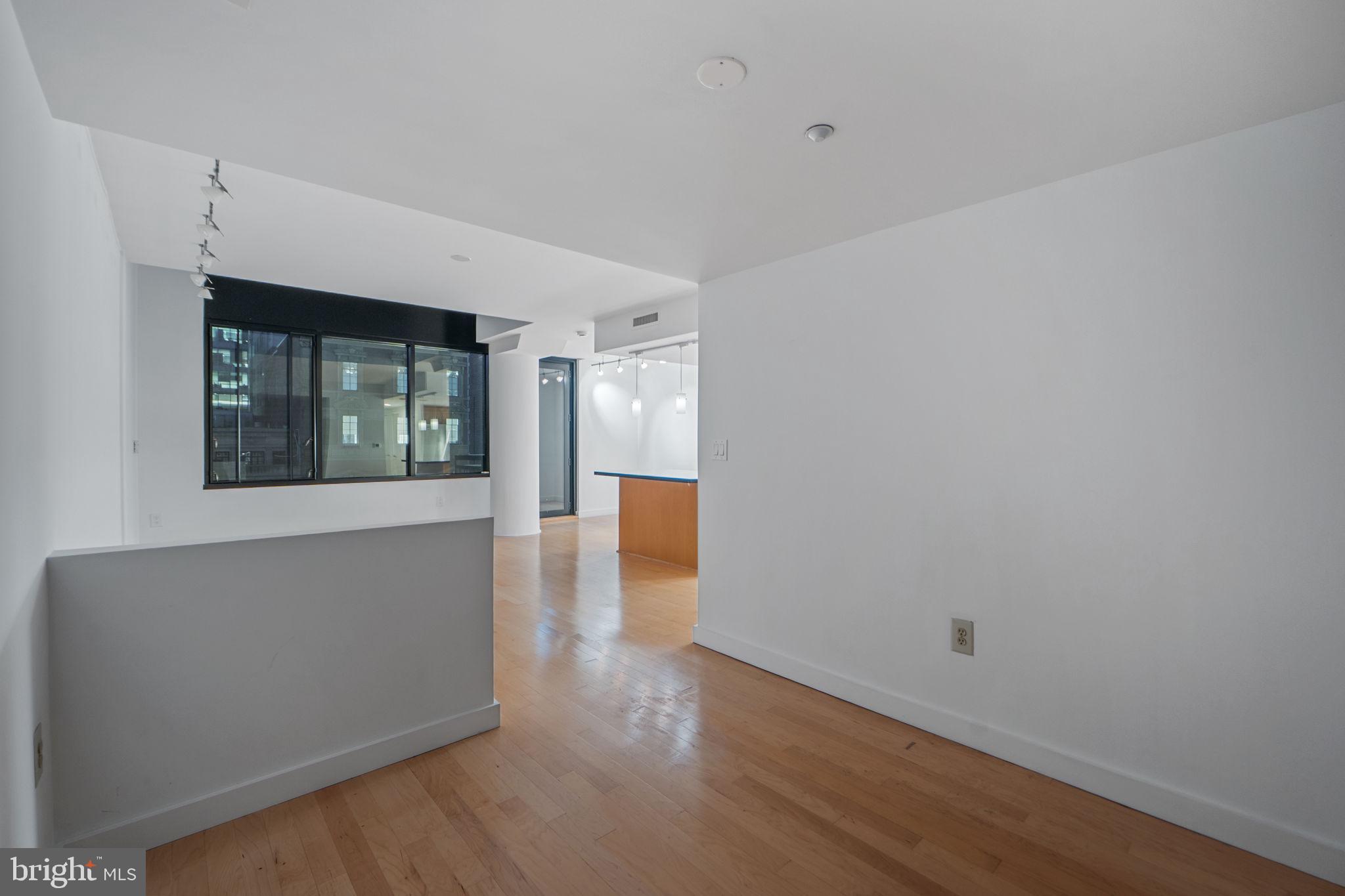912 F Street Northwest, Unit 508 Washington, DC 20004 - Photo 26 of 40 wooden floor in an empty room with a window