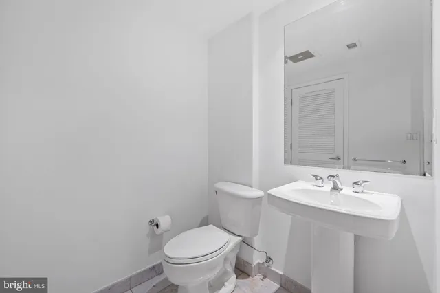 a view of an empty room with window and bathroom