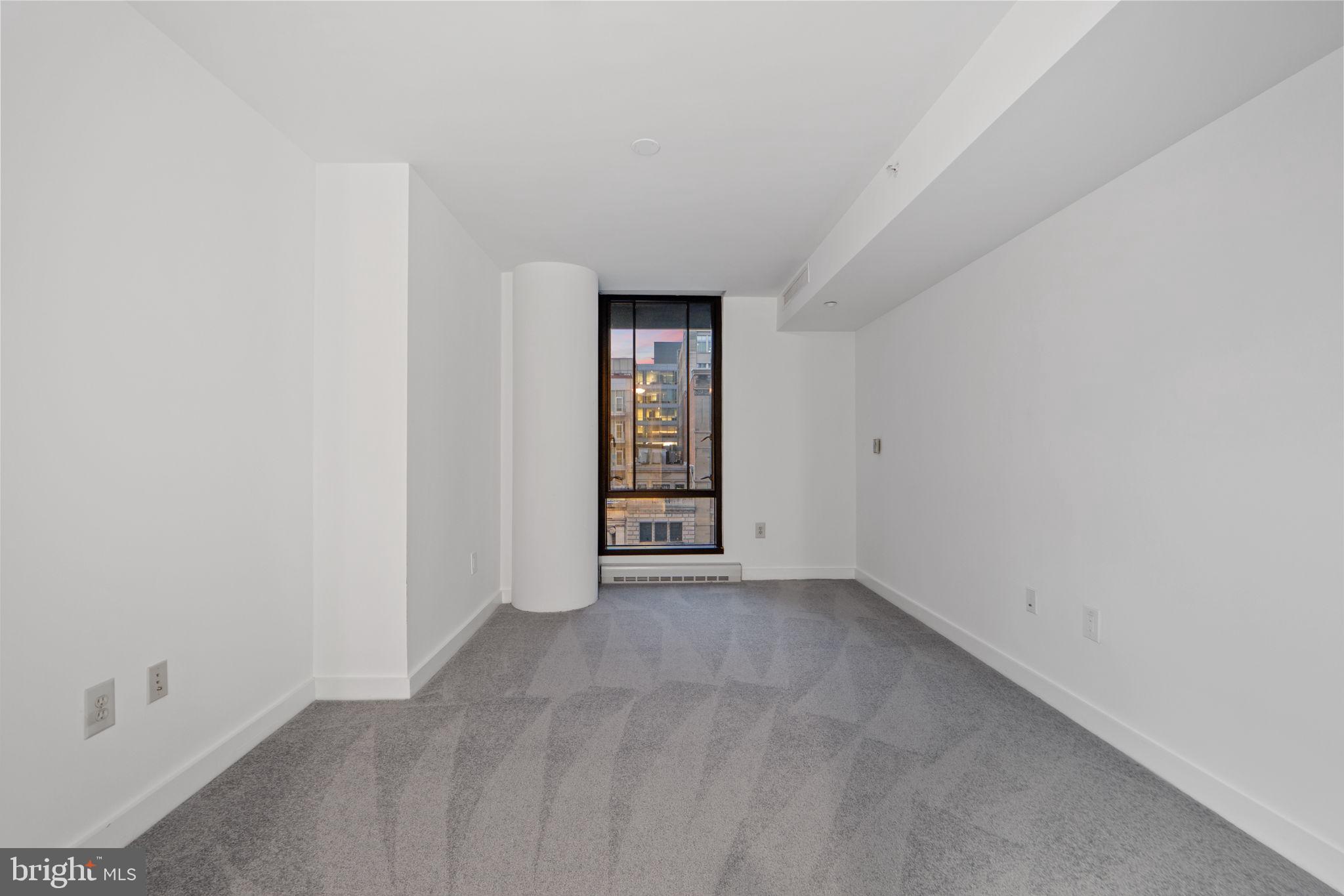 912 F Street Northwest, Unit 508 Washington, DC 20004 - Photo 29 of 40 a view of an empty room with window and bathroom