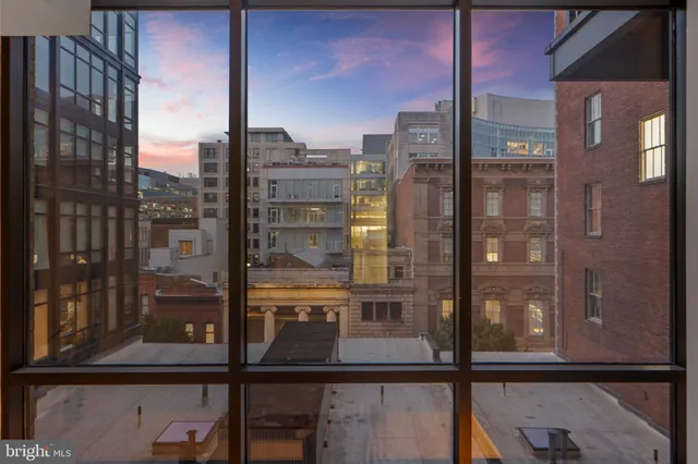 a bedroom with a large bed and a potted plant