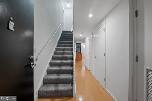 a view of entryway and hall with wooden floor