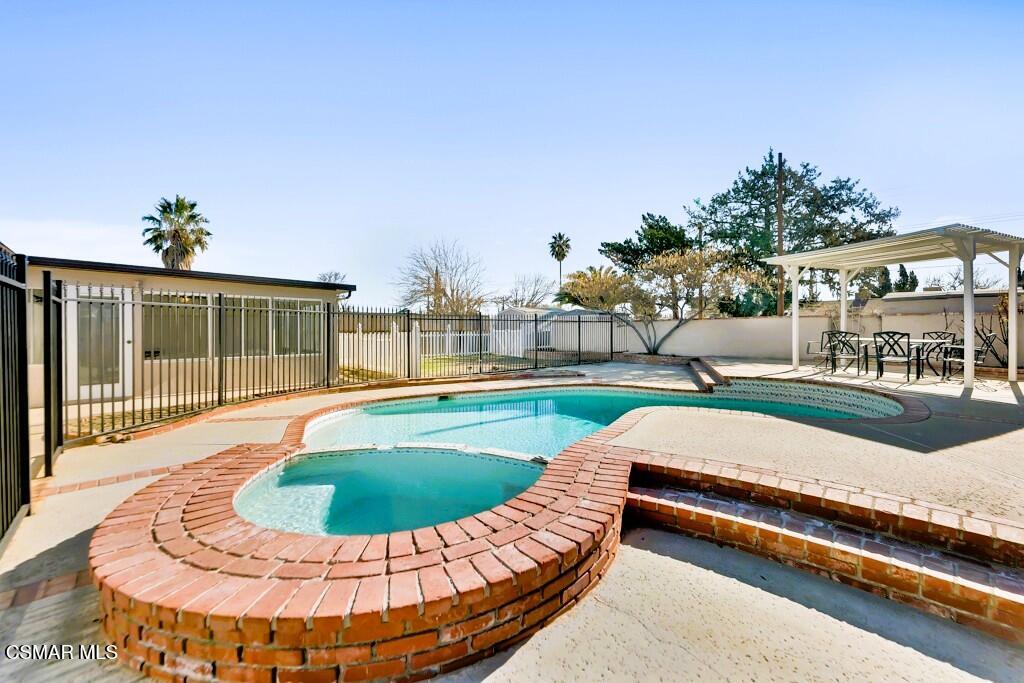 a view of a swimming pool with a lounge chair