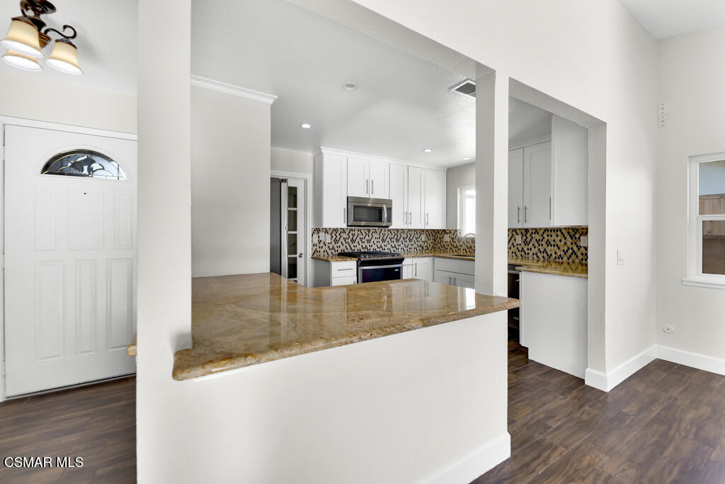 39202 Willowvale Road Palmdale, CA 93551 - Photo 12 of 36 a view of a kitchen cabinets kitchen and wooden floor