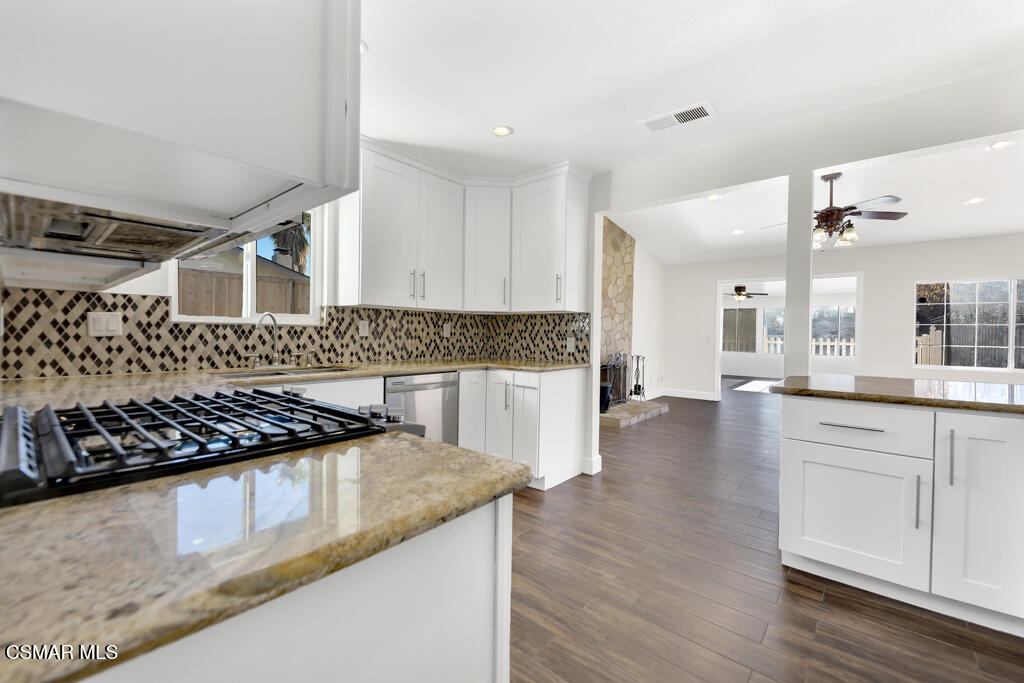 39202 Willowvale Road Palmdale, CA 93551 - Photo 13 of 36 a kitchen with granite countertop a stove and cabinets