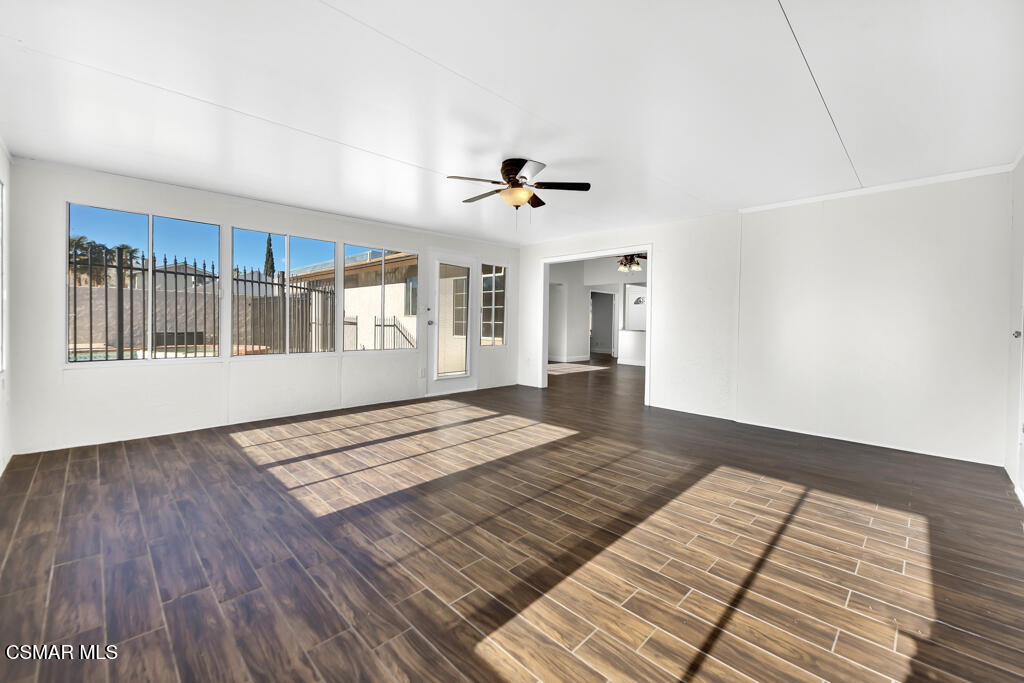 39202 Willowvale Road Palmdale, CA 93551 - Photo 14 of 36 a view of an empty room with a window and wooden floor